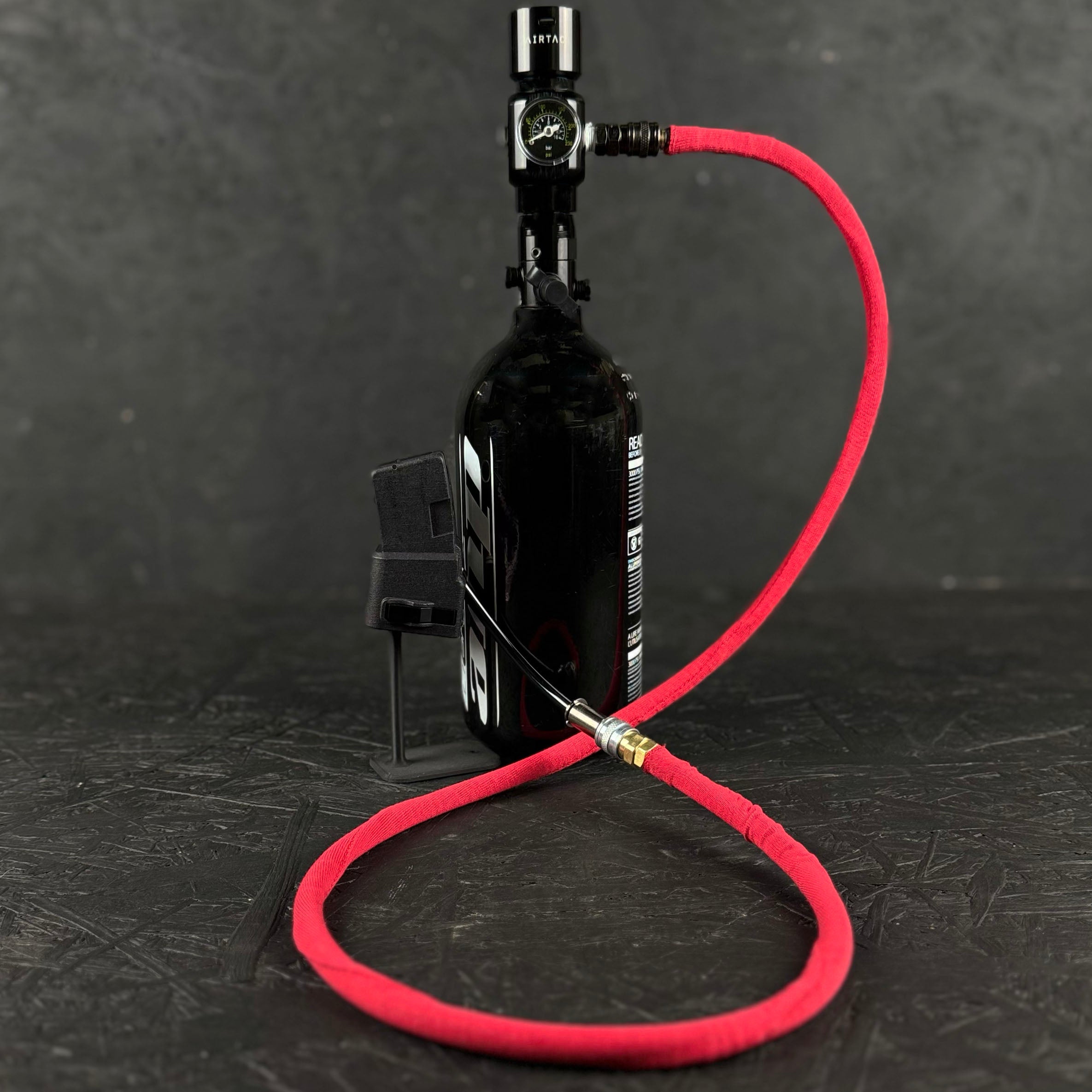 Photo of red Airtac Line Cover attached to adapter and reg