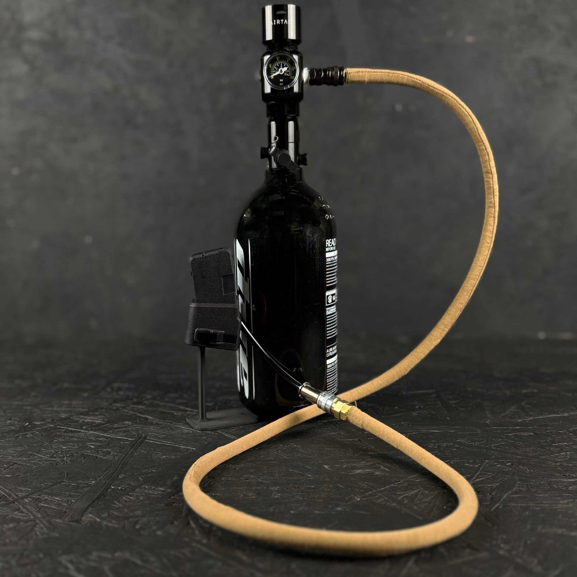 Photo of tan Airtac Line Cover attached to adapter and reg