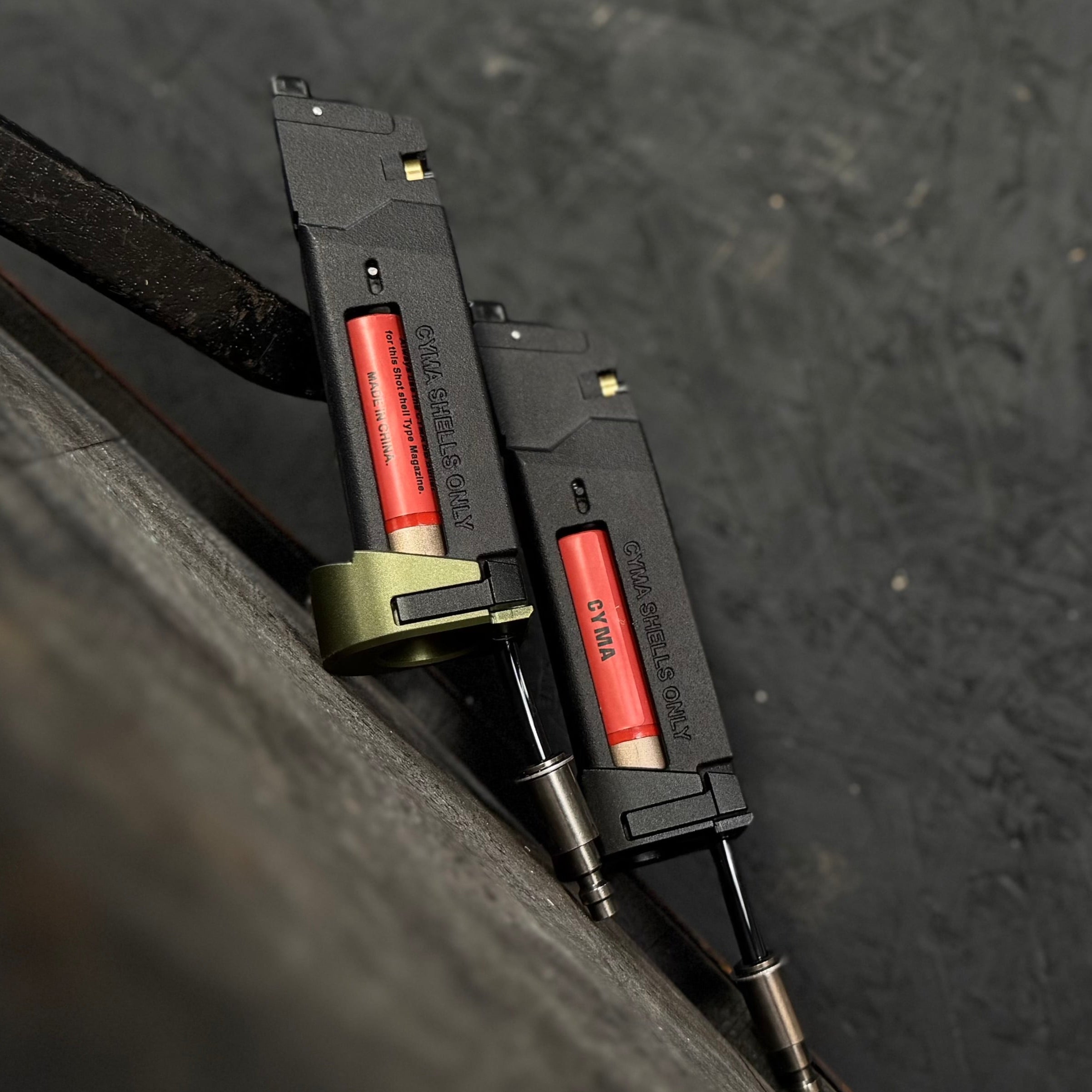 Photo of two AIRTAC X T1P MK23/SSX303/SSX23 Shotgun Shell HPA Adapters. One with a green base and one with a black base