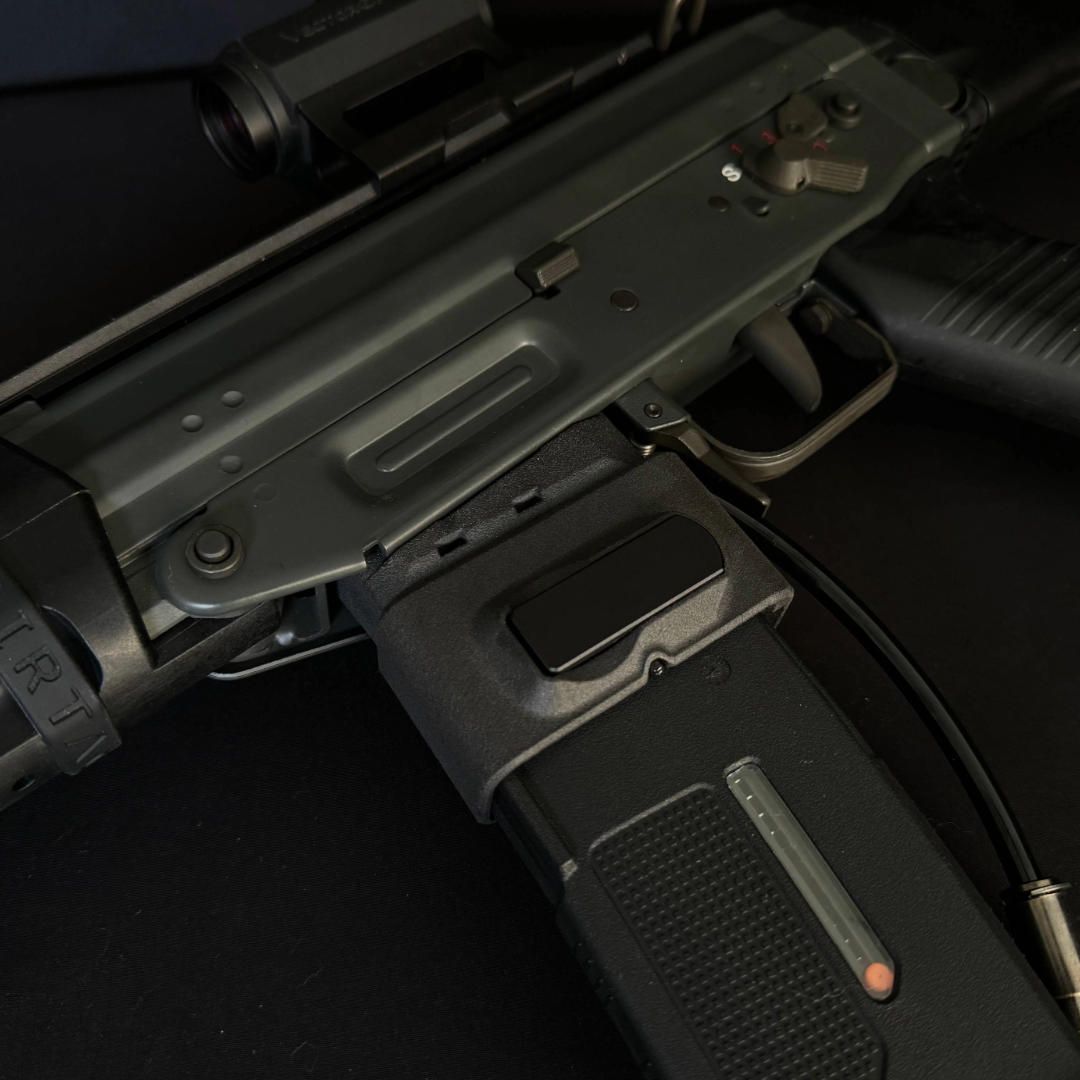 Close up photo of AIRTAC GHK 553 HPA Adapter (Modular) - PLUG AND PLAY in RIF with M4 magazine