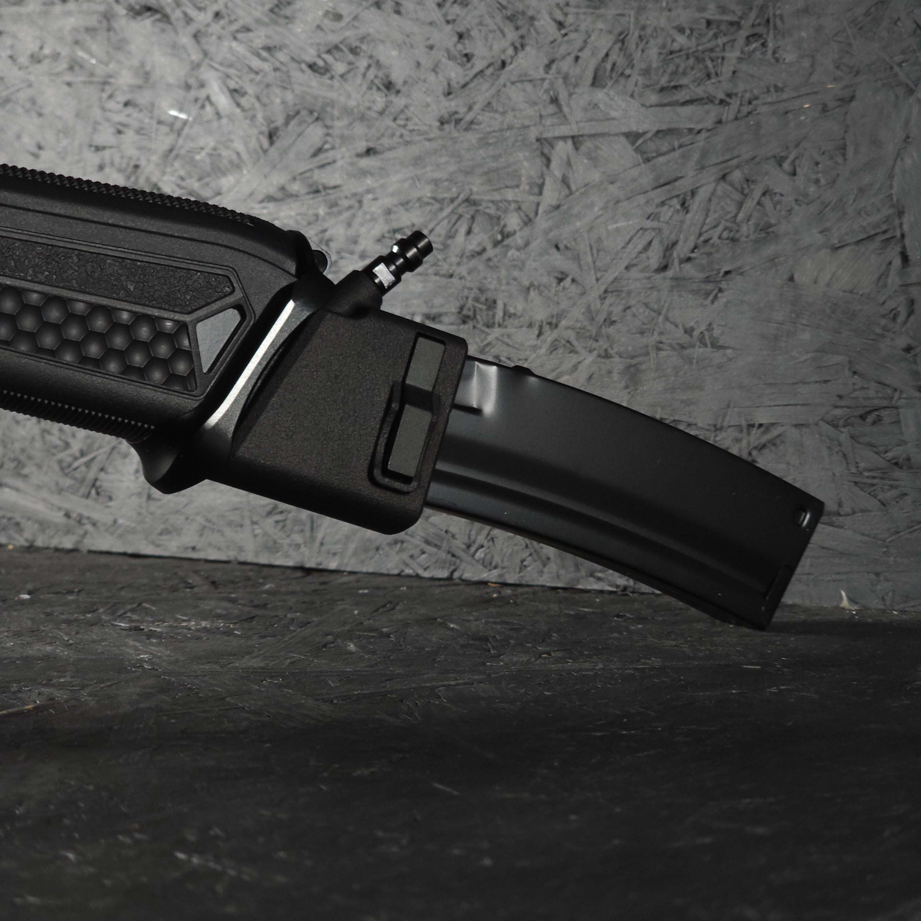 Close up photo of AIRTAC Glock/APP to MP5 adapter in RIF with short magazine